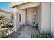 Charming front porch with decorative columns and a cozy seating area with a chair at 4319 E Tanglewood Dr, Phoenix, AZ 85048