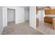 Open-concept living area featuring neutral carpet, white walls, and access to the kitchen at 4319 E Tanglewood Dr, Phoenix, AZ 85048