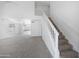Bright living room showcasing a staircase, neutral carpet, and large windows for ample light at 4319 E Tanglewood Dr, Phoenix, AZ 85048