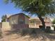 Well-maintained home with desert landscaping, mature tree, and charming architectural details at 45290 W Buckhorn Trl, Maricopa, AZ 85139