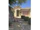 Inviting front entrance with a charming entryway, desert landscaping, and a well-manicured yard at 45290 W Buckhorn Trl, Maricopa, AZ 85139