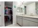 Bathroom featuring dual sinks, granite countertops, and an open walk-in closet for added storage at 4701 S Siphon Draw Rd, Apache Junction, AZ 85119