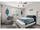 Bedroom boasts a comfortable gray lounge chair, a bed with blue accents, and shuttered windows for relaxing comfort at 4701 S Siphon Draw Rd, Apache Junction, AZ 85119