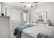 Bedroom featuring a bed with white frame and blue bedding, a ceiling fan, and a mirrored dresser with gray accents at 4701 S Siphon Draw Rd, Apache Junction, AZ 85119