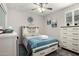 Comfortable bedroom featuring a white bed frame, light blue covers, modern wall art, and a matching dresser at 4701 S Siphon Draw Rd, Apache Junction, AZ 85119