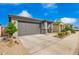 Lovely single-story home featuring a well-maintained front yard, and a two-car garage with a paved driveway at 4701 S Siphon Draw Rd, Apache Junction, AZ 85119