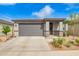 Charming single-story home featuring a well-maintained front yard and a two-car garage, with stone accents and neutral paint at 4701 S Siphon Draw Rd, Apache Junction, AZ 85119