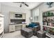 Comfortable office space featuring a gray chair with ottoman, desk with cabinets and open shelving, and built-in bookcase at 4701 S Siphon Draw Rd, Apache Junction, AZ 85119
