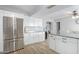 Bright kitchen featuring modern stainless steel appliances, stylish wood floors, and white cabinetry at 4815 W Charleston Ave, Glendale, AZ 85308