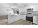 Updated kitchen boasts stainless steel appliances, granite countertops, wood floors, and abundant cabinet space at 4815 W Charleston Ave, Glendale, AZ 85308