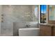 Elegant bathroom with a freestanding tub, marble walk-in shower, and high-end fixtures at 4911 E Amelia Ave, Phoenix, AZ 85018