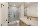 Modern bathroom featuring a glass-enclosed shower, stylish vanity, and updated fixtures at 4911 E Amelia Ave, Phoenix, AZ 85018