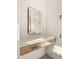 Bright bathroom featuring floating vanity, sleek mirror and modern design elements at 4911 E Amelia Ave, Phoenix, AZ 85018