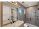 Contemporary bathroom with neutral tiles, large mirror, glass shower, and sleek black fixtures at 4911 E Amelia Ave, Phoenix, AZ 85018
