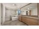 Luxurious bathroom with a soaking tub, walk-in shower, dual vanity, and modern finishes at 4911 E Amelia Ave, Phoenix, AZ 85018