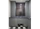Chic bathroom featuring gray cabinets, stainless steel sink, black and white checkered floors at 4911 E Amelia Ave, Phoenix, AZ 85018