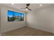 Bright bedroom with hardwood floors, ceiling fan, and a large window offering mountain views at 4911 E Amelia Ave, Phoenix, AZ 85018