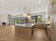 Open concept kitchen with island, hardwood floors, fireplace and backyard views at 4911 E Amelia Ave, Phoenix, AZ 85018