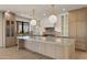 Beautiful gourmet kitchen featuring a large center island, custom cabinets, and pendant lighting at 4911 E Amelia Ave, Phoenix, AZ 85018