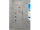 Elegant shower with marble tile, rainfall shower head, and brass fixtures at 4911 E Amelia Ave, Phoenix, AZ 85018