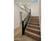 Elegant staircase with wood treads and black metal railing enhances the home's modern aesthetic at 4911 E Amelia Ave, Phoenix, AZ 85018