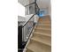 Well-lit staircase featuring wood steps and modern black railing, adding style and functionality at 4911 E Amelia Ave, Phoenix, AZ 85018