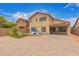 A spacious backyard features a brick-paved area, a grassy area, playground set, and a two-story home at 5123 W Novak Way, Laveen, AZ 85339