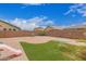 The backyard features a grassy area, a brick-paved patio, and is enclosed by a block wall for privacy at 5123 W Novak Way, Laveen, AZ 85339
