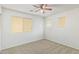 Carpeted bedroom with a ceiling fan and three windows at 5123 W Novak Way, Laveen, AZ 85339