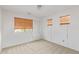 Empty carpeted bedroom featuring three windows with light brown blinds at 5123 W Novak Way, Laveen, AZ 85339