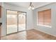 Bright dining area featuring tile floors, sliding glass doors to the patio, and a window with wood blinds at 5123 W Novak Way, Laveen, AZ 85339