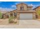 Charming two-story home with a well-maintained front yard, a two-car garage and a tile roof at 5123 W Novak Way, Laveen, AZ 85339