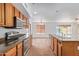 Modern kitchen with stainless steel appliances, an island with a sink, and wood cabinets at 5123 W Novak Way, Laveen, AZ 85339