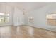 Spacious living room featuring wood-look floors, bright lighting, and vaulted ceilings at 5123 W Novak Way, Laveen, AZ 85339