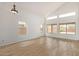 Large living room with many windows, vaulted ceilings, and wood-look tile floors at 5123 W Novak Way, Laveen, AZ 85339