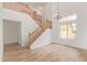 Open living area showcasing a staircase with wood railing, wood-look floors, and vaulted ceilings at 5123 W Novak Way, Laveen, AZ 85339