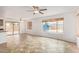Living area with sliding glass doors to the backyard, tiled floors, and a ceiling fan at 5123 W Novak Way, Laveen, AZ 85339