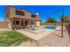 A comfortable backyard with covered patio, well-kept pool, and tidy landscaping at 6101 W Sunnyside Dr, Glendale, AZ 85304