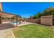 Spacious backyard with lush lawn, refreshing pool, and cozy patio seating at 6101 W Sunnyside Dr, Glendale, AZ 85304