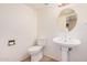 Powder room featuring pedestal sink, oval mirror, and neutral tones at 6101 W Sunnyside Dr, Glendale, AZ 85304