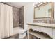 Cozy bathroom featuring a shower-tub combination with tiled walls and countertop at 6101 W Sunnyside Dr, Glendale, AZ 85304