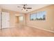 Bedroom with sliding closet, fan, and natural lighting at 6101 W Sunnyside Dr, Glendale, AZ 85304