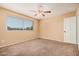 Bedroom with blinds, fan, and ample natural light at 6101 W Sunnyside Dr, Glendale, AZ 85304