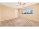 Bright bedroom with carpet, fan, and a sunny window view at 6101 W Sunnyside Dr, Glendale, AZ 85304
