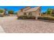 Charming home featuring a balcony, arched window, two-car garage, and desert landscaping at 6101 W Sunnyside Dr, Glendale, AZ 85304