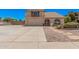 Charming home featuring a balcony, arched window, two-car garage, and low maintenance landscaping at 6101 W Sunnyside Dr, Glendale, AZ 85304