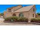 Charming home featuring a balcony, arched window, two-car garage, and desert landscaping at 6101 W Sunnyside Dr, Glendale, AZ 85304
