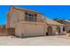 Charming home featuring a balcony, arched window, two-car garage, and desert landscaping at 6101 W Sunnyside Dr, Glendale, AZ 85304