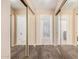Hallway with mirrored closet doors leads to bathroom and bedroom at 6101 W Sunnyside Dr, Glendale, AZ 85304