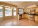 Bright eat-in kitchen featuring stainless steel appliances, tile floors, and ample natural light from the adjacent bay windows at 6101 W Sunnyside Dr, Glendale, AZ 85304